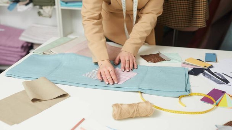 At Last: The Secret to Fashion Designer Is Revealed Stock Photo Designer Working with Fabric